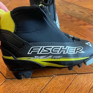 Kids cross country ski boots, size EU 28. Color is black with like green